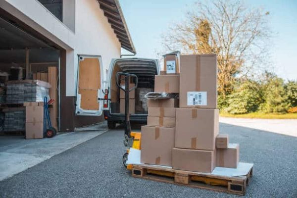 Packages on a forklift in front of the delivery van Packages on a forklift in front of the delivery van